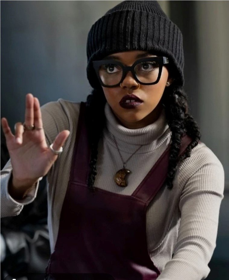a young black woman in a black hat and glasses